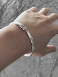 M.A+ Thin Silver Stitched Cross silver Bangle